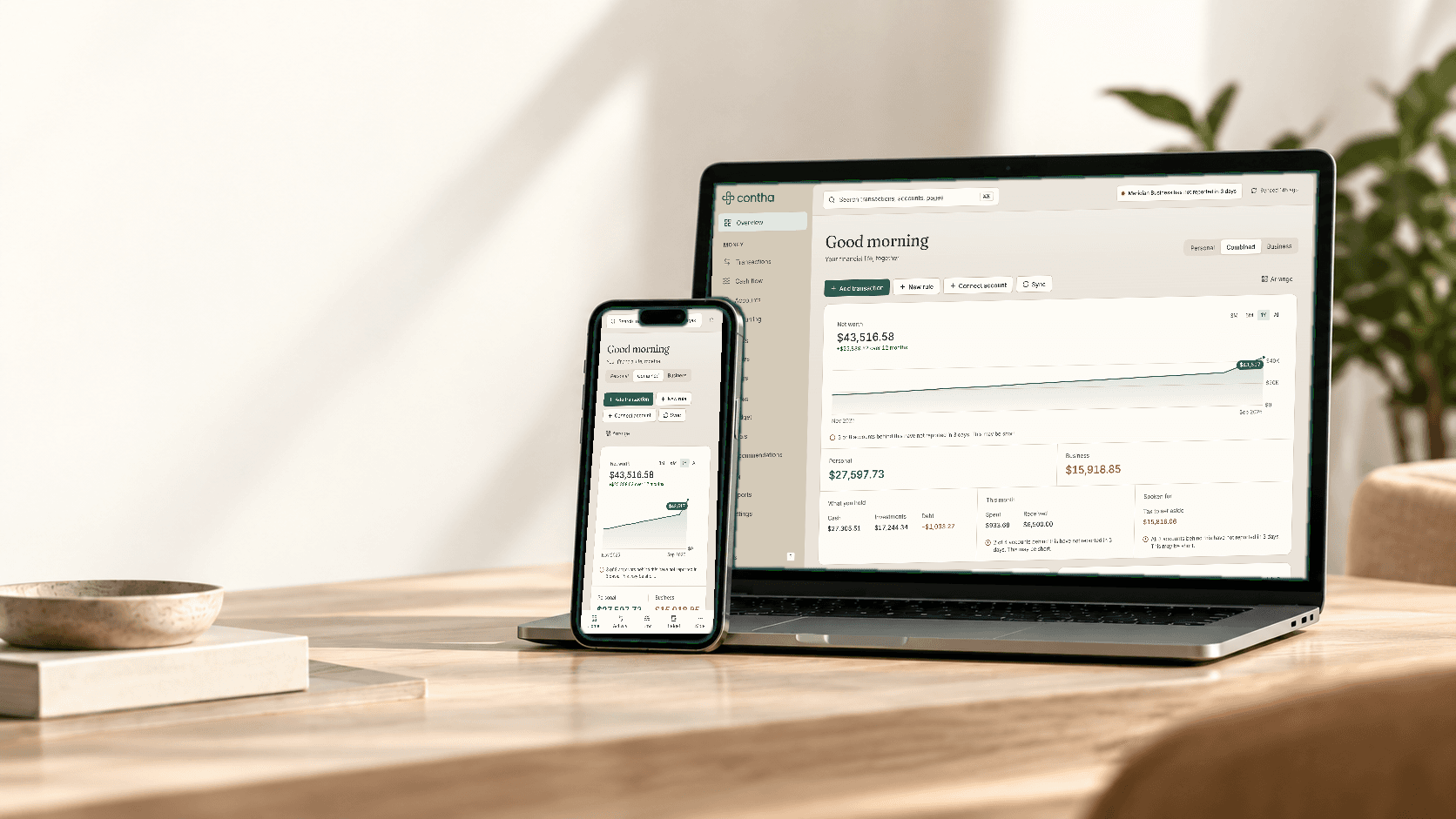 Contha open on a laptop and a phone: net worth across a year, split
into personal and business, with what needs attention